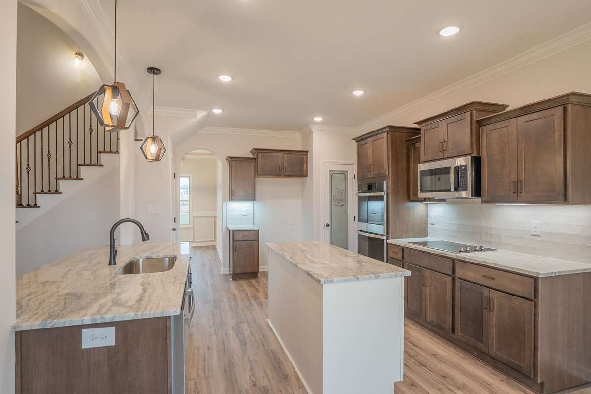 EXAMPLE >>>Large Kitchen with a Cooktop, Smart Double Oven, Granite Countertops, Tile Backsplash, Recessed Lighting, Serving Bar and Lots of Cabinetry - All with Soft Close Doors & Drawers!!