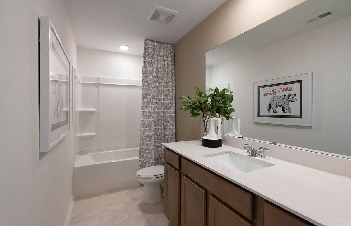 ***Photo is from a brand new Rosella Model home*** Bath #2 includes tile flooring and quartz countertops.
