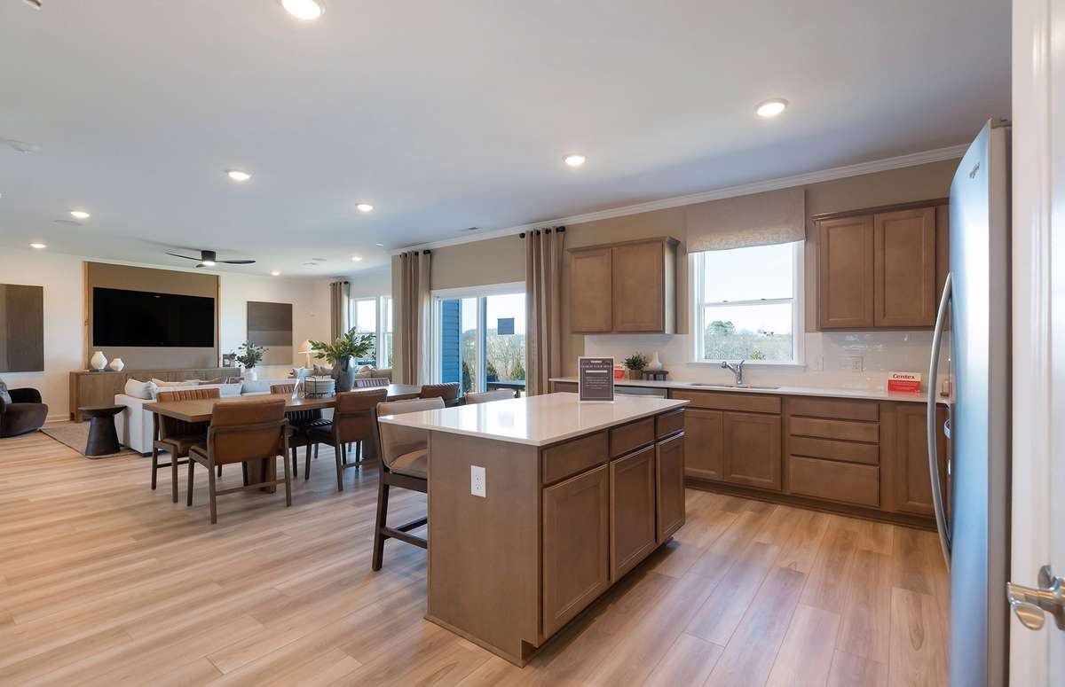 ***Photo is from a brand new Rosella Model home*** The island provides additional storage space while also being the perfect location for quick meals.