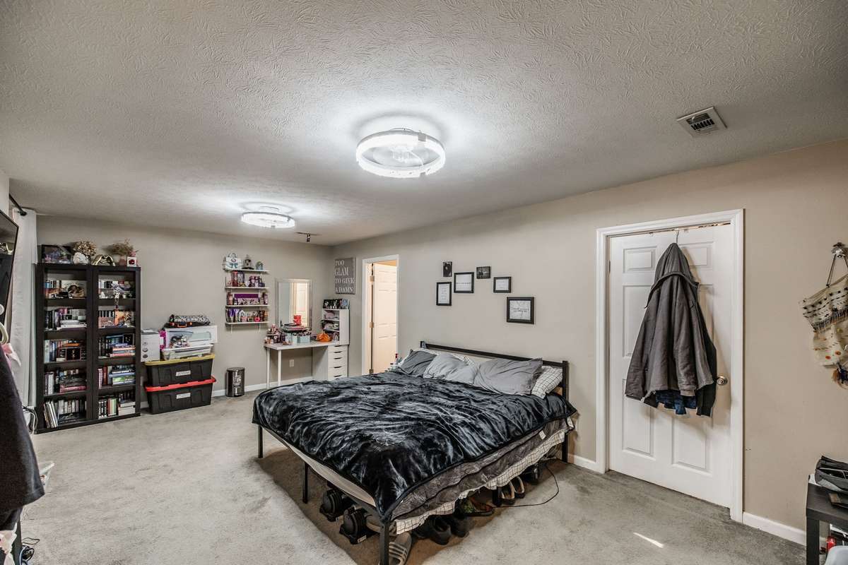 Large room currently being used as the main suite with walk-in closet and adjoining bathroom