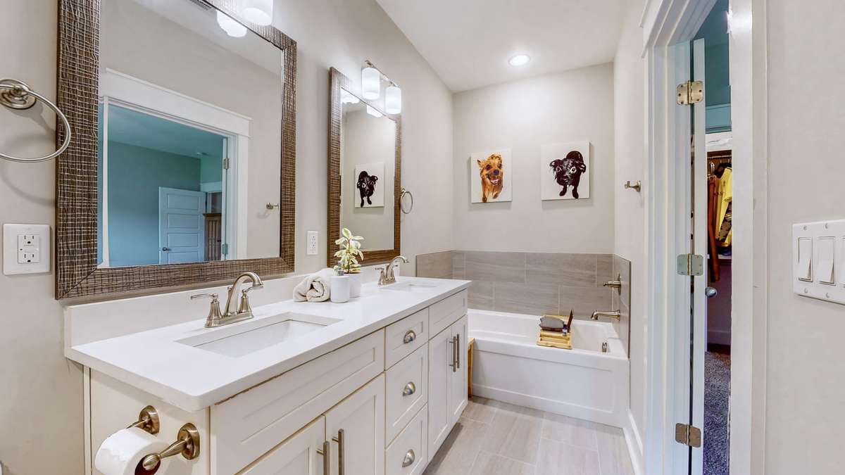 Primary Suite Bathroom features double vanities shower & soaking tub (and great lighting!)