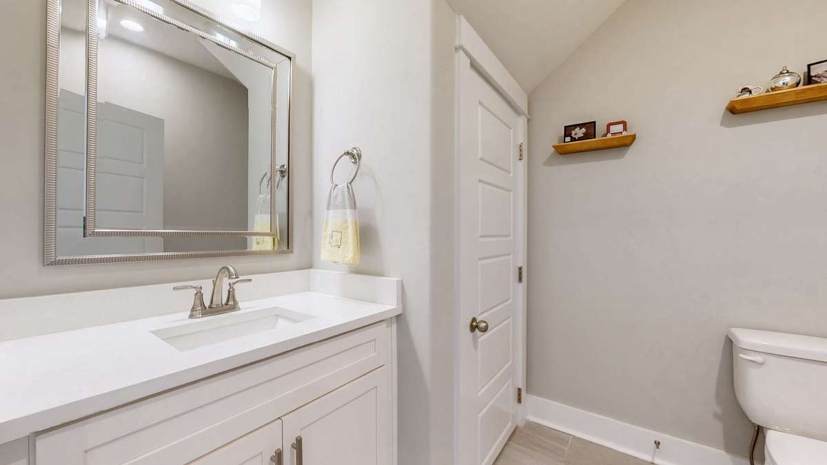 Main level half bath with full linen closet