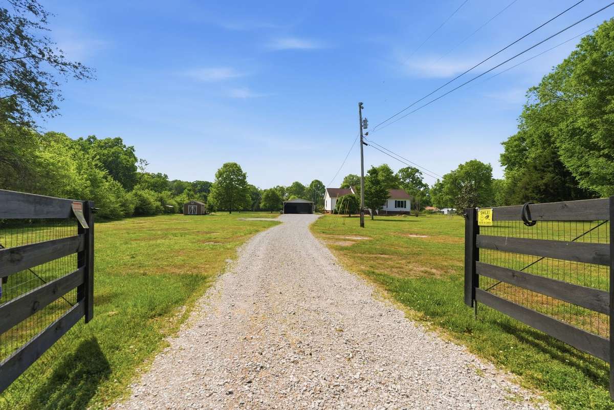 Fully fenced w/ split rail fence & operable gate about 1/3 way down on property.