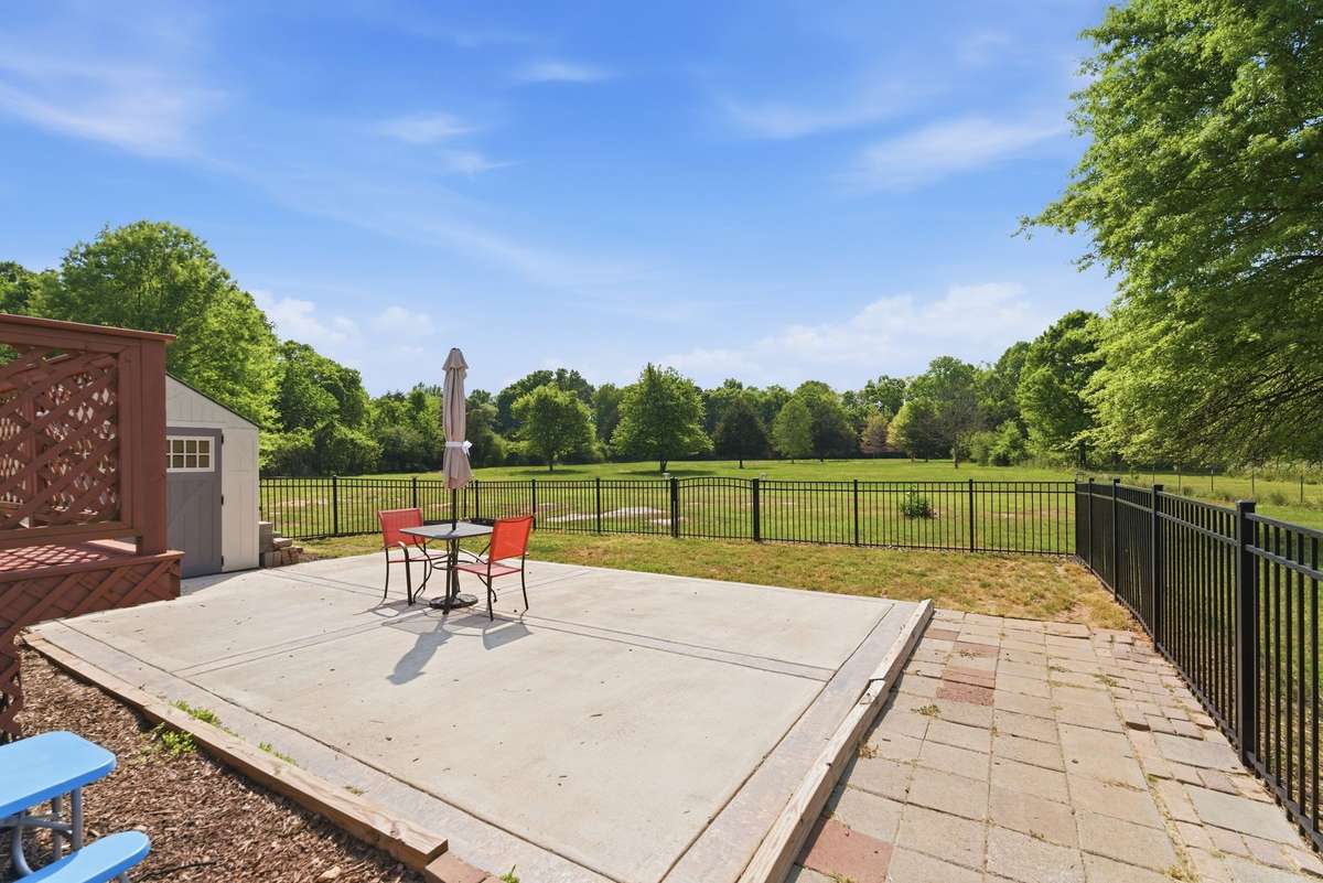 New concrete patio slab and aluminum fencing.