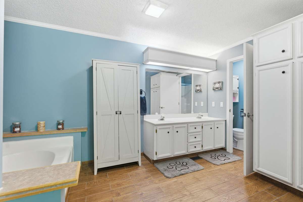 Double vanities, built in cabinet storage, separate tub and shower and water closet.
