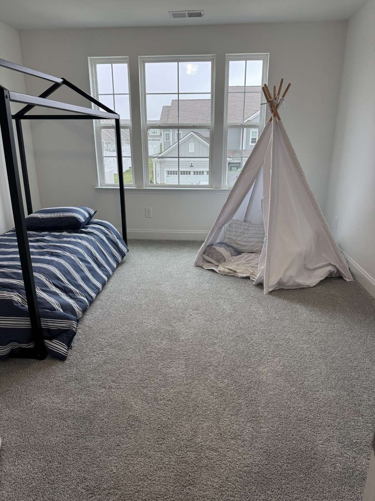 upstairs bedroom 2 faces the front of the townhome with 3 windows for natural light