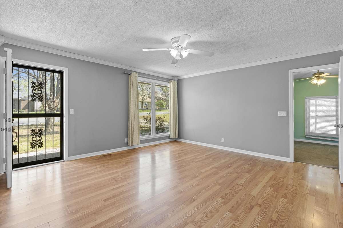 Great Room With Laminate Hardwood Flooring And Ceiling Fan