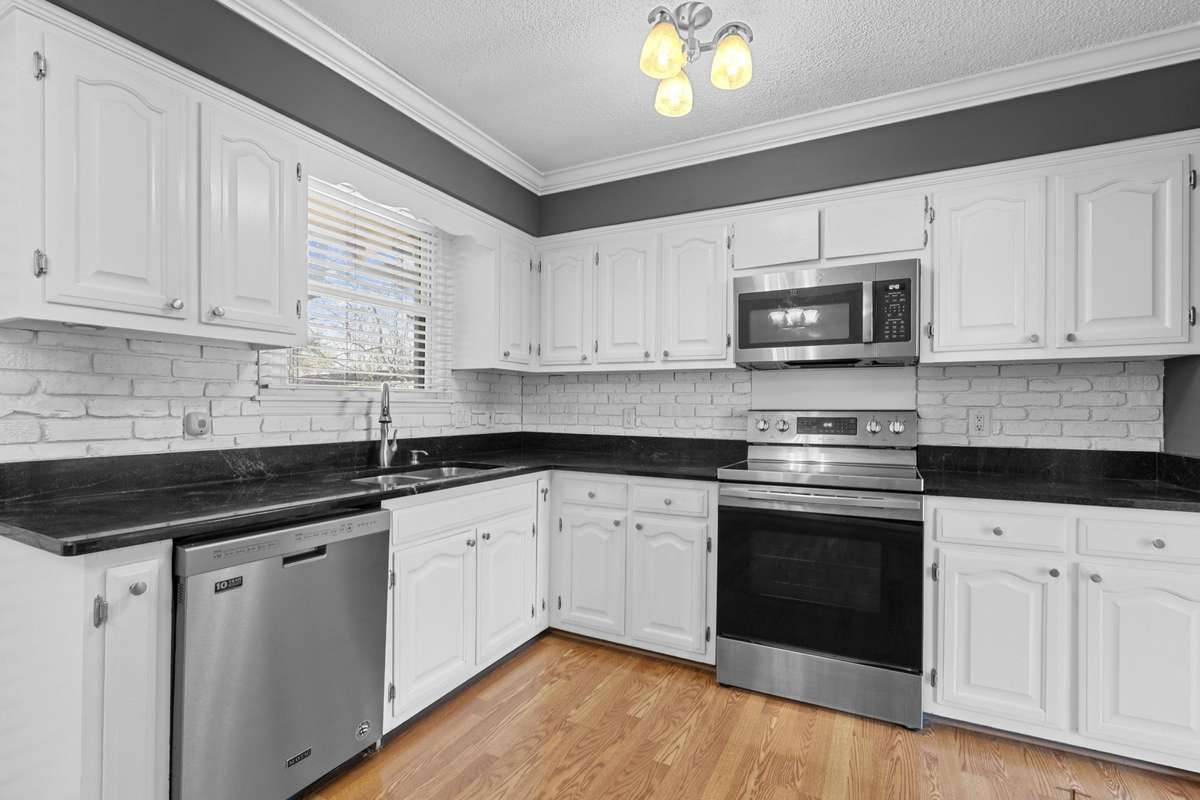 Kitchen With Stainless Dishwasher, Microwave And Stove