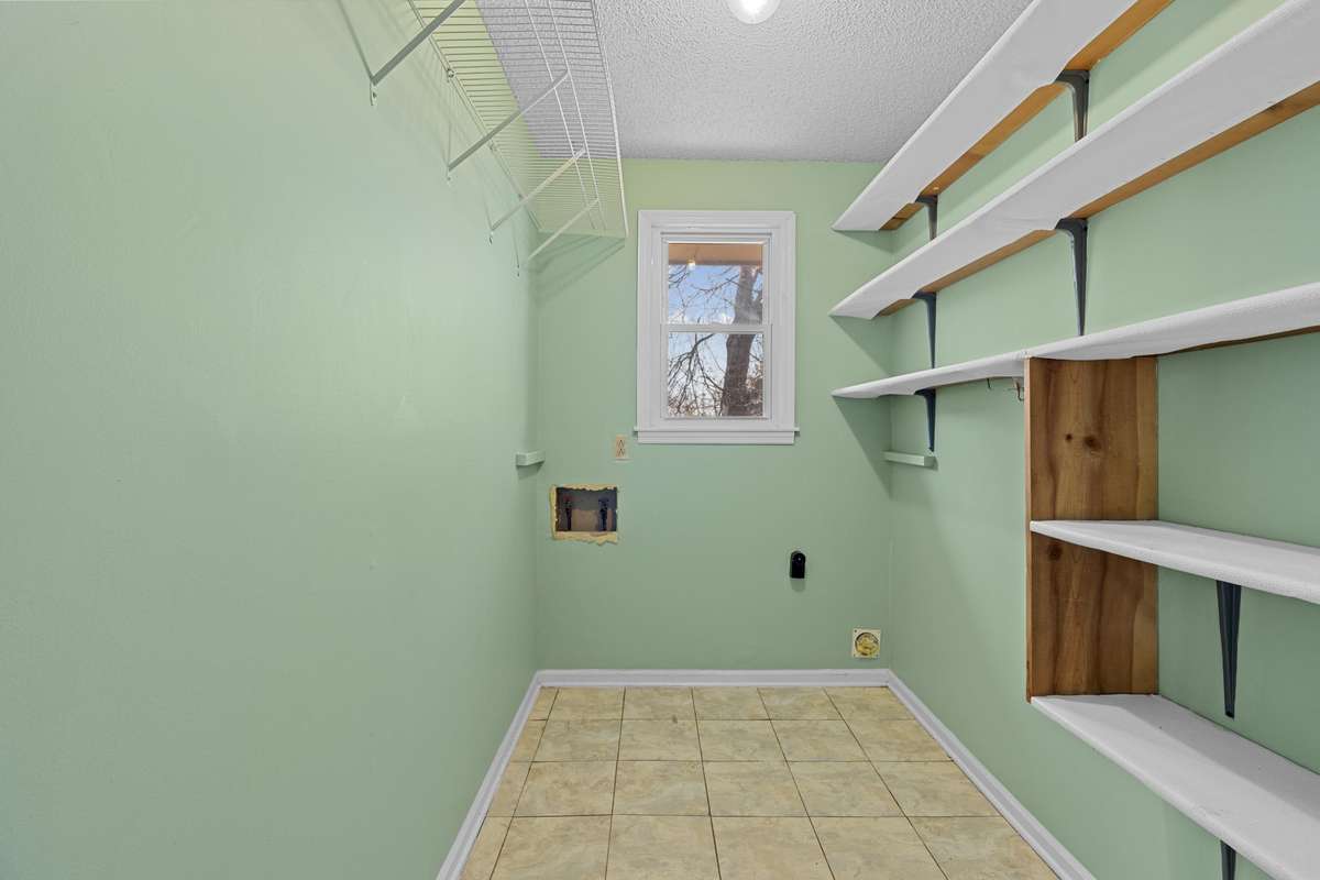 Large Utility Room With Shelving And Tile Flooring