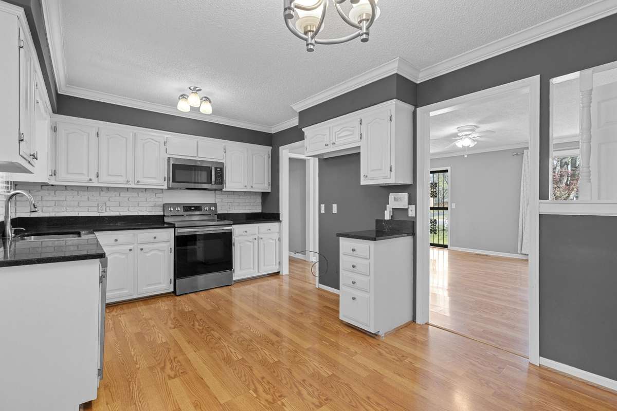 Kitchen With Granite Counters And Laminate Hardwood Flooring