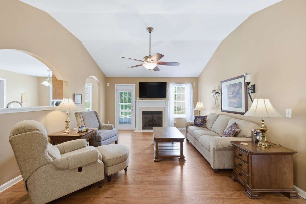 Open living room with high ceiling and gas fireplace