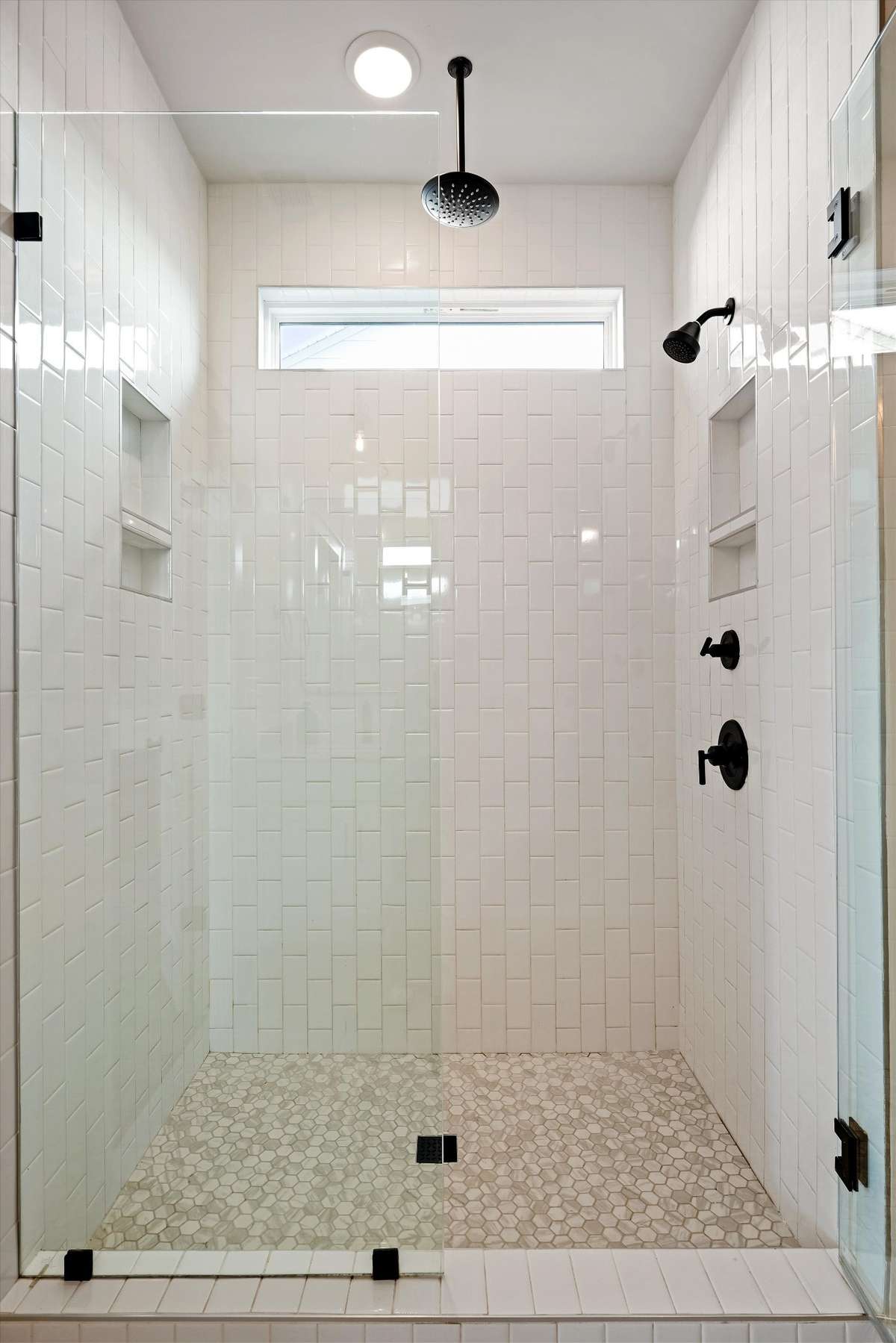 Floor to ceiling shower tile with a rain shower included