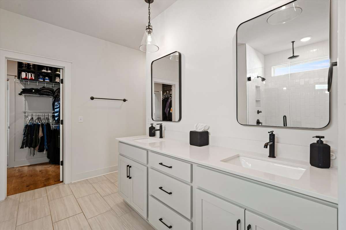 Double sinks and plenty of cabinet storage plus a linen closet