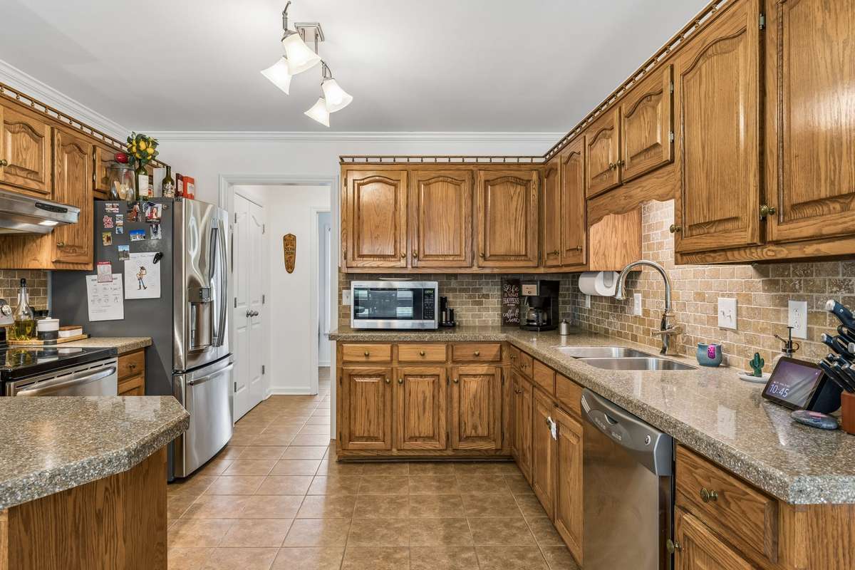 Granite countertops with an oversized stainless sink & tile floor make clean up easy. 2104 Red Mile Rd, Murfreesboro, TN 37127