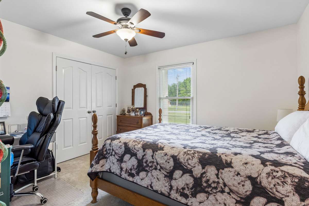 Bedroom three has a double closet, ceiling fan and carpeted floor. 2104 Red Mile Rd, Murfreesboro, TN 37127