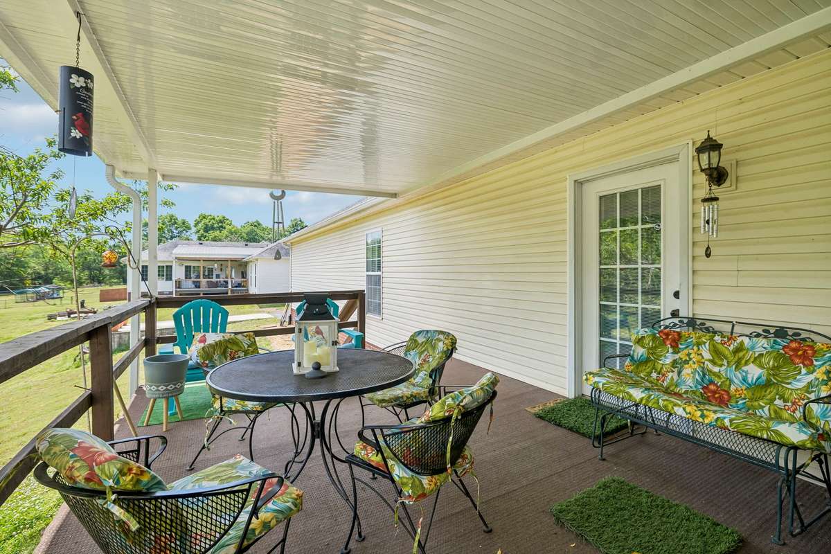 Spacious rear covered deck to enjoy your morning coffee and possibly see some deer wander through!