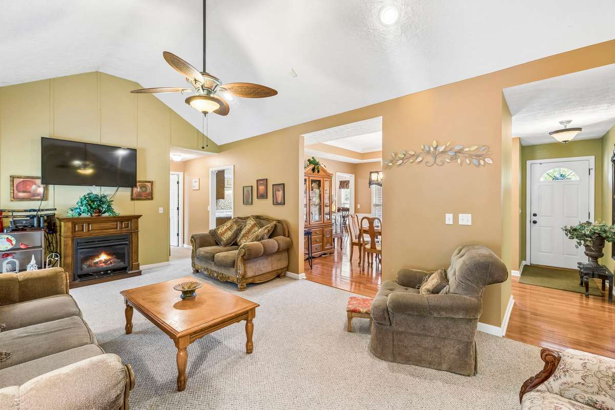 The Living Room has a natural gas fireplace, vaulted ceiling and carpet flooring (carpeting in this home is a neutral color and nicely kept)!