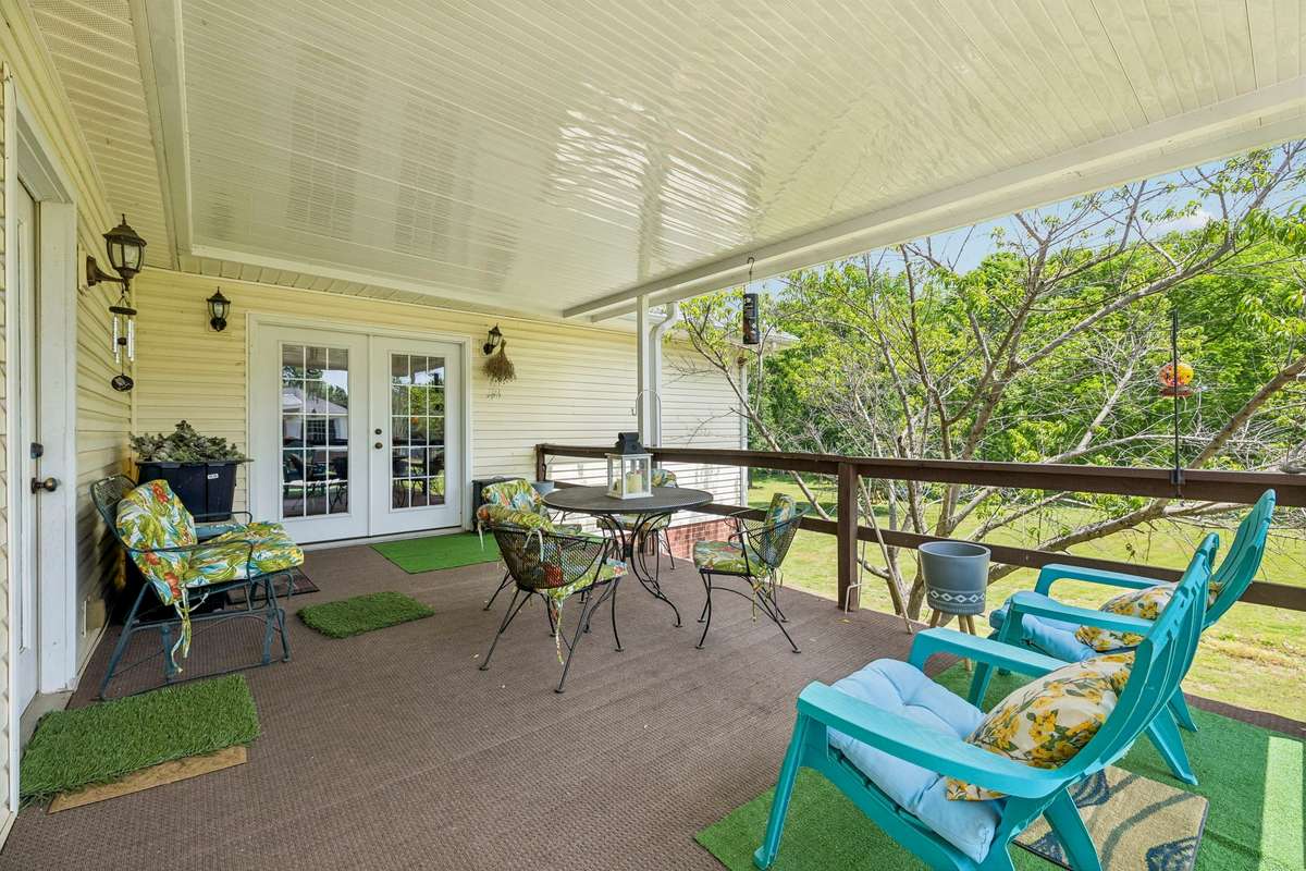 The rear covered deck had the roof added by the Sellers to make it more usable and has awesome views of the serene and peaceful back yard! This is a great 3-season place to entertain family and friends!