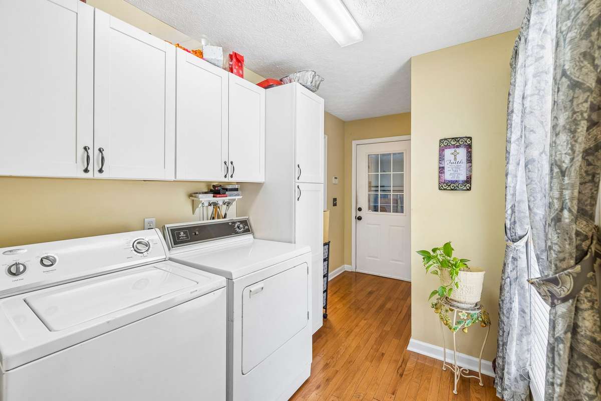 The Laundry Room is off the kitchen with great cabinetry for storage and the hardwood flooring. Washer & Dryer do not remain but may be negotiable! The doorway is to the garage.