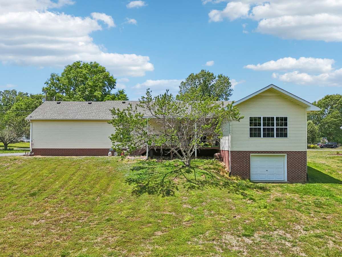 The back yard view of the home! There is a garage door with a 12 x 17 storage area that can also serve as a tornado shelter if needed!