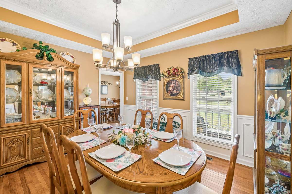 The Dining Room with the Kitchen doorway in the rear.  All blinds and curtains remain with the home.