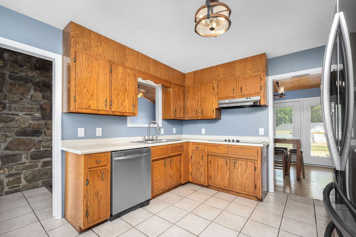 Window cut out above the kitchen sink overlooking the living room area.