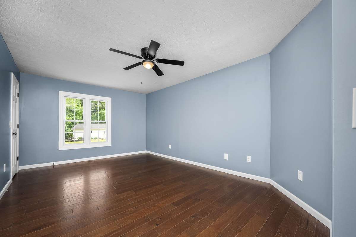 The primary bedroom is spacious and features a flush mounted ceiling fan and double window overlooking the back yard.
