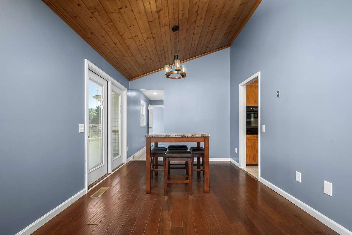 The dining area is located just off the kitchen and living room. Its also vaulted and features a double windowed door leading out onto the back deck.