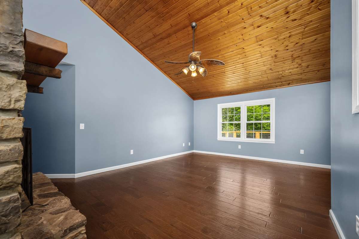 Engineered hardwood floors, double window overlooking the back yard and ceiling fan.