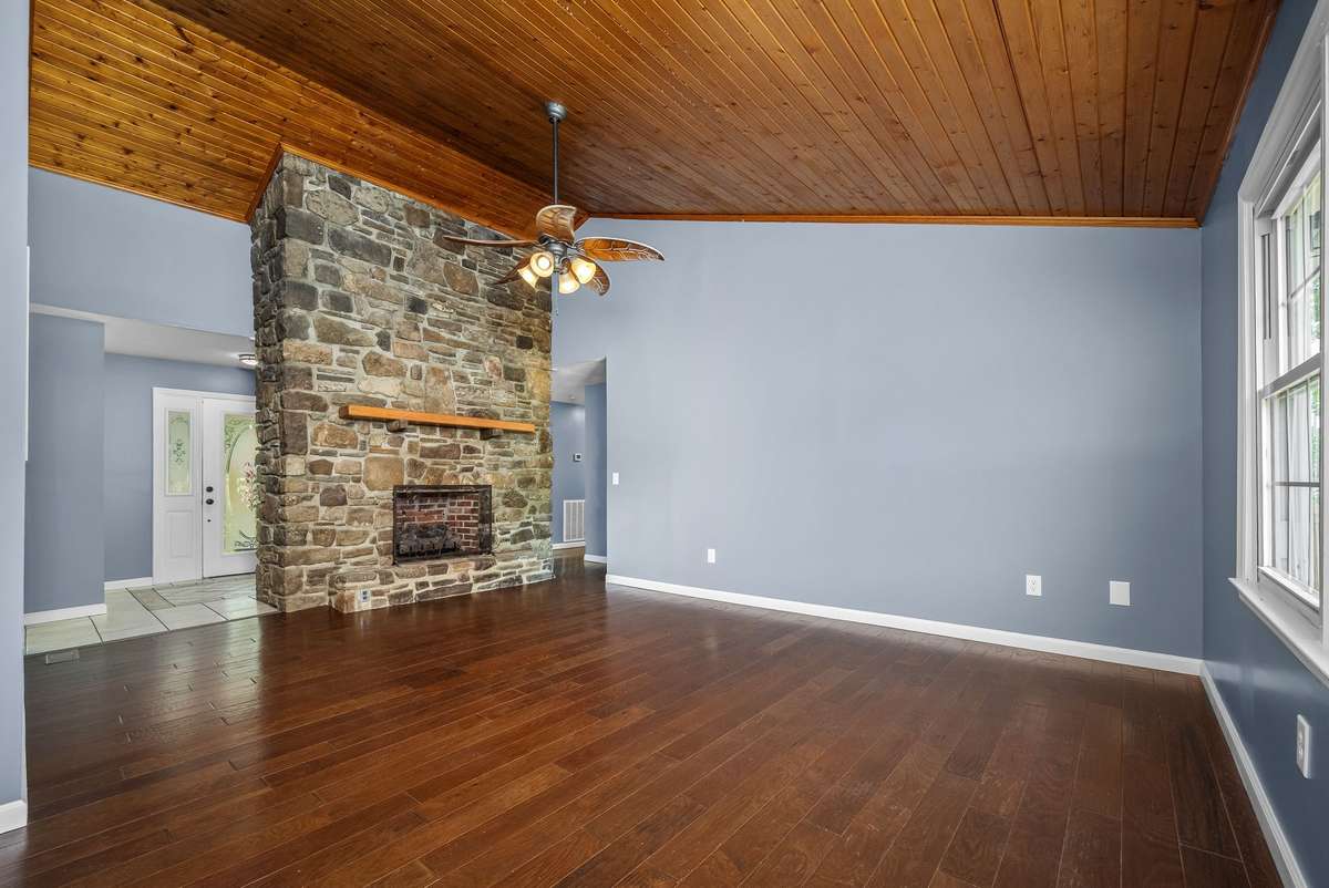 The living room welcomes you with vaulted, tongue and groove wood ceiling and an oversized rock fireplace.