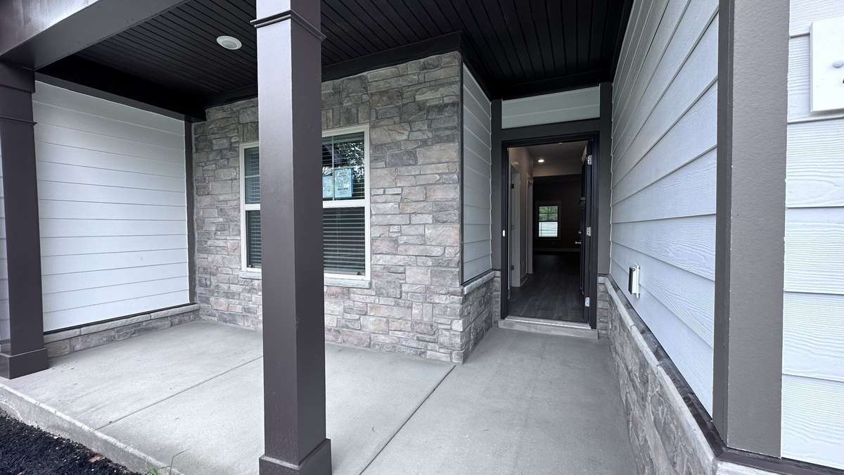 File photo NEW end unit 3/3, 2 car, 2 bedrms down/2 bath, 1 bedrm/bath up, great rm/kitchen, covered back porch, patio/Blinds/stainless pkg/refrigerator/kitchen Tile backsplash/under cabinet lighting/Owners Tile shower/laminate/carpet/tile & more!