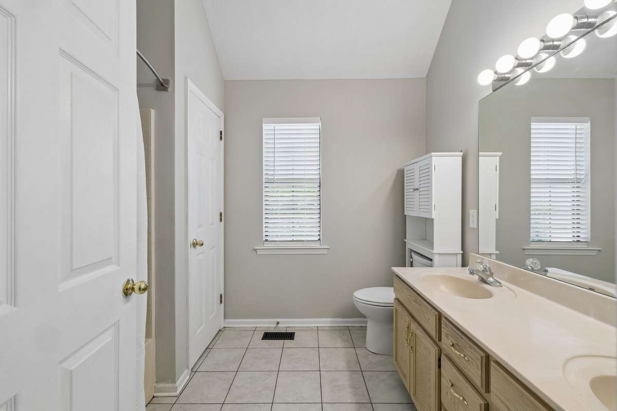 Primary Bathroom with double vanity and garden/tub combo shower