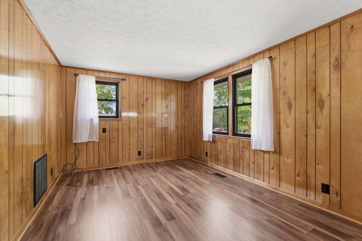 Living room with original wood paneling are just one of the many features that give this home character and charm