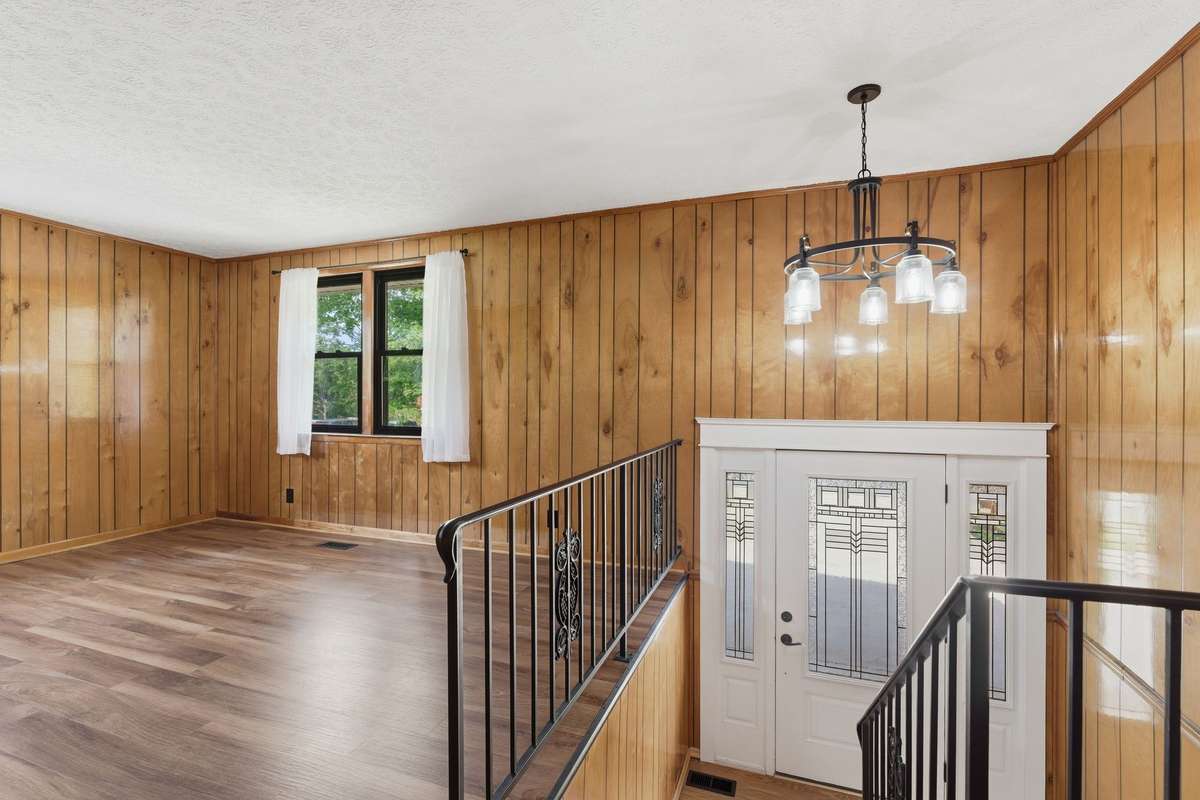 Entryway with custom chandelier greets guests as they arrive