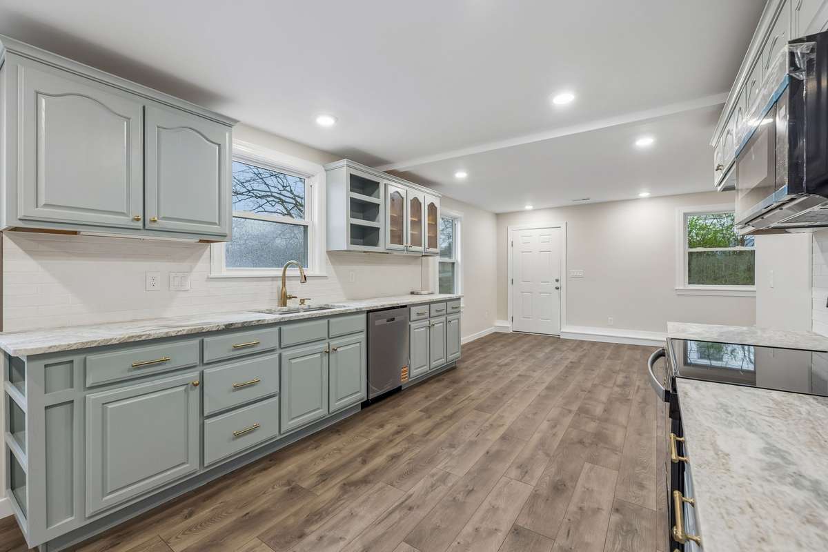 Kitchen features leathered granite countertops, tile backsplash, stainless appliances and under cabinet lighting.