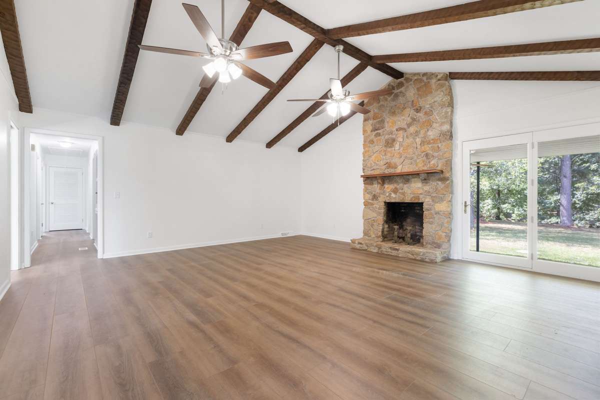Exposed stained beams give this den so much character.