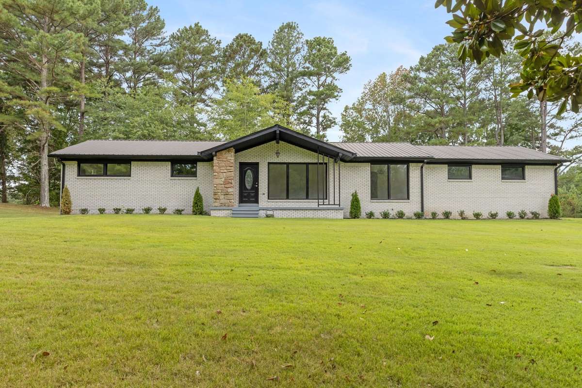 Adorable ranch home sits on 3 acres near golf course.