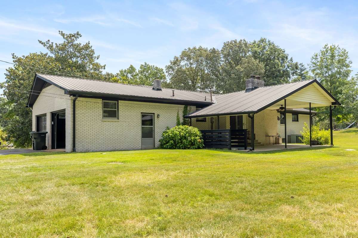 Covered back porch made perfect for entertaining or morning coffee sipping
