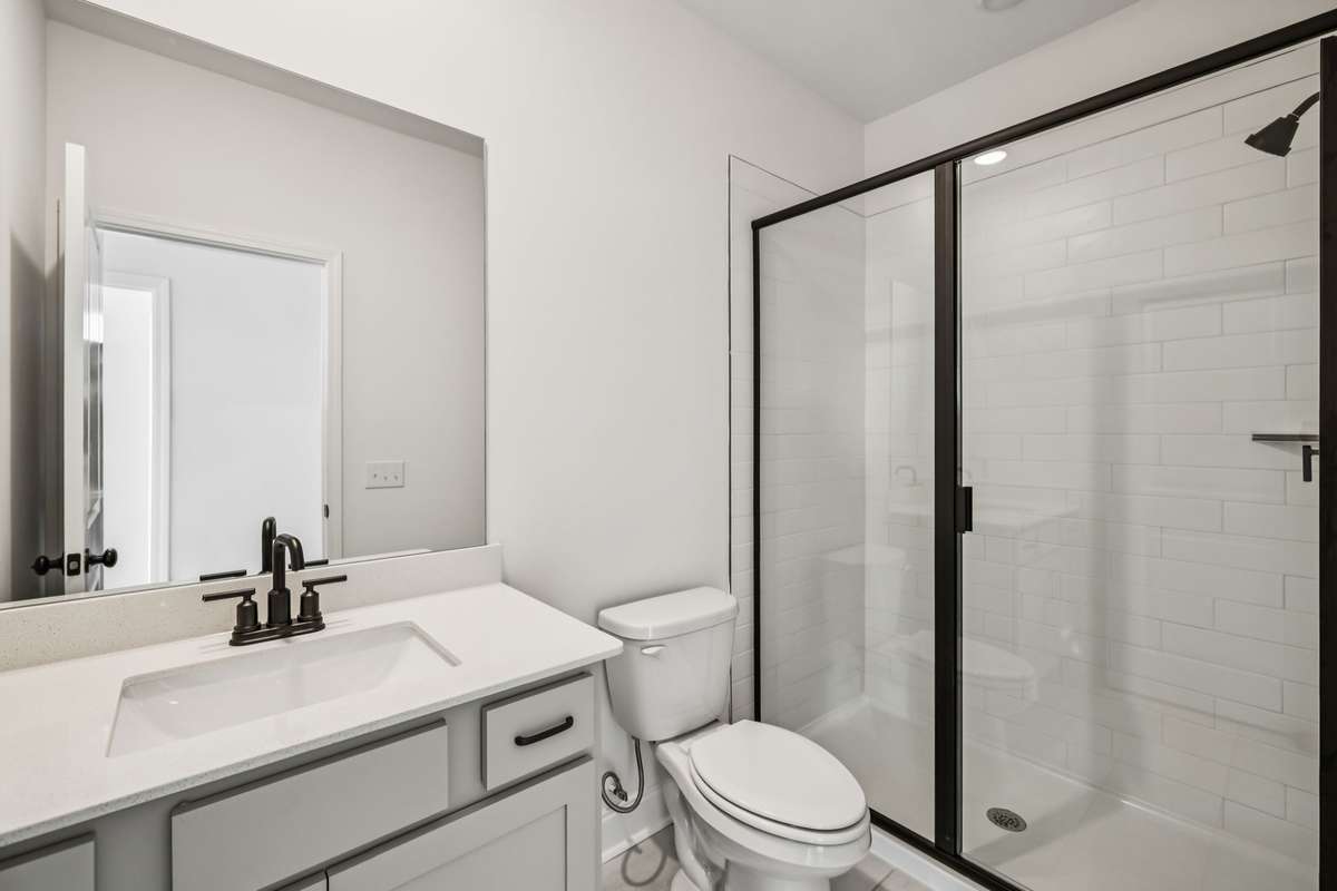 *Photos are from a previous Jordan Floorplan - Colors may vary*

A full Bathroom with a tiled walk-in shower is included on the 1st floor just off of the Guest Retreat.