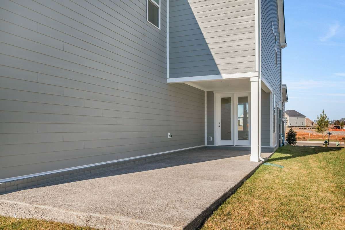 Covered patio on the side of the house with additional concrete is the perfect area to entertain.(Photos of similar home)