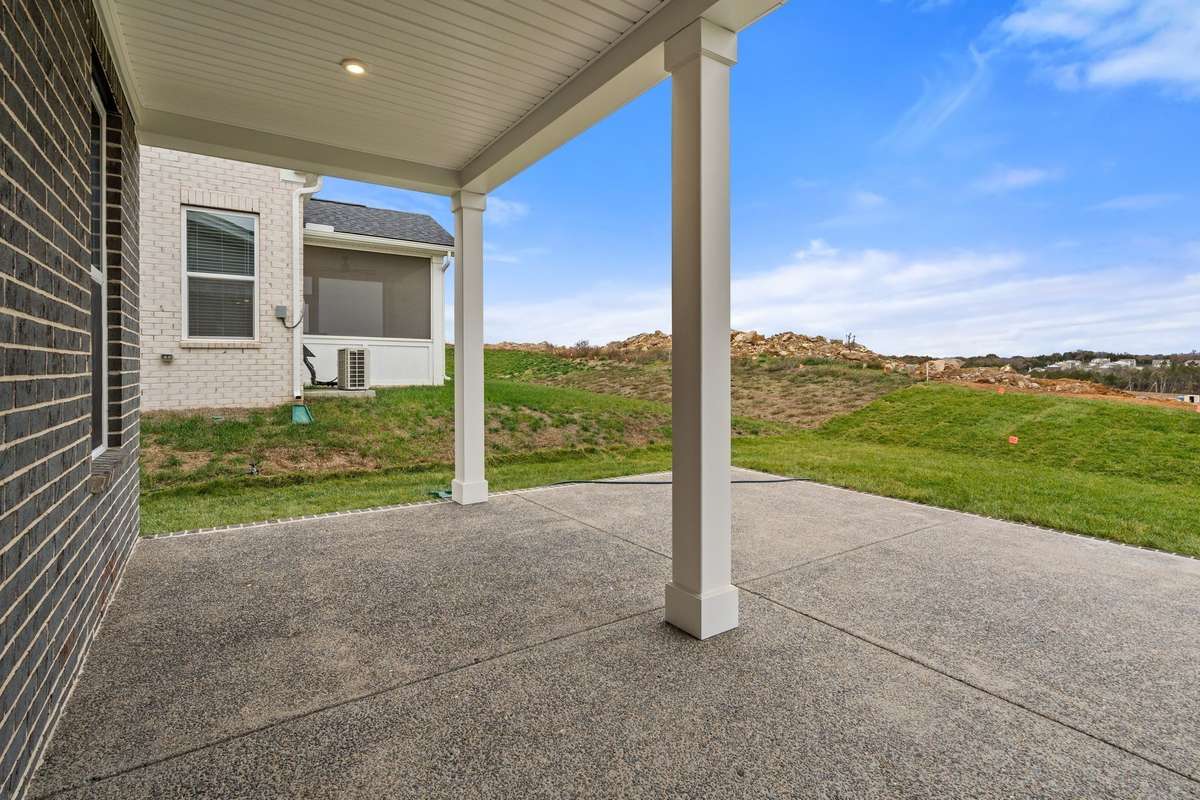 Covered patio with added concrete.