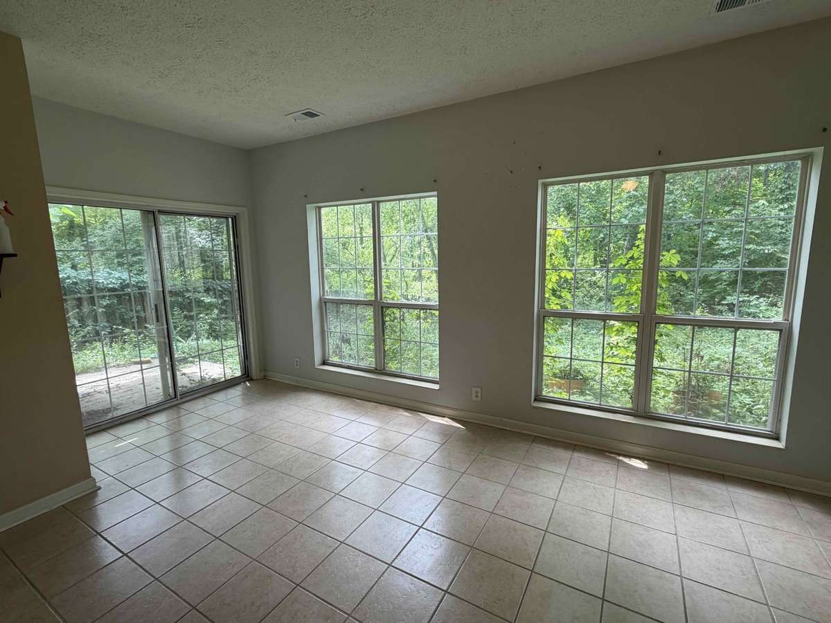 Lower-level living space with tile flooring, perfect for a second living area, media room, or rental setup.