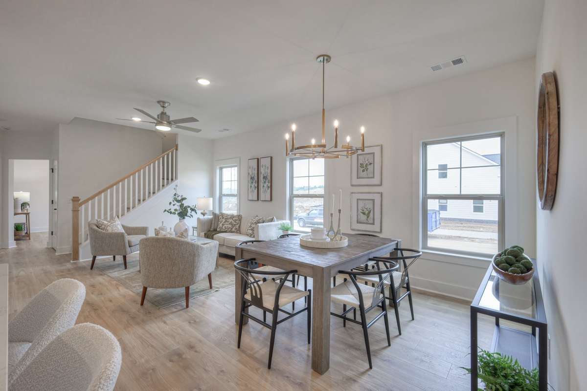 **Photos of the model home living & dining to show the layout of the floor plan staged with furniture. Not the actual house.**