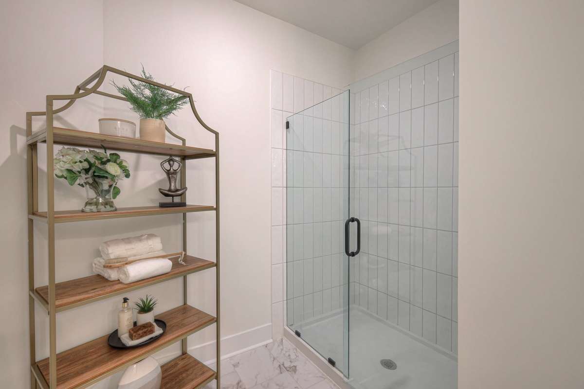 **Photos of the model home owners shower on the main level to show the layout of the floor plan staged with furniture. Not the actual house.**