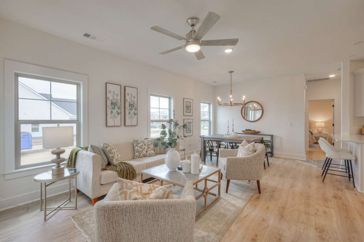 **Photos of the model home living & dining to show the layout of the floor plan staged with furniture. Not the actual house.**