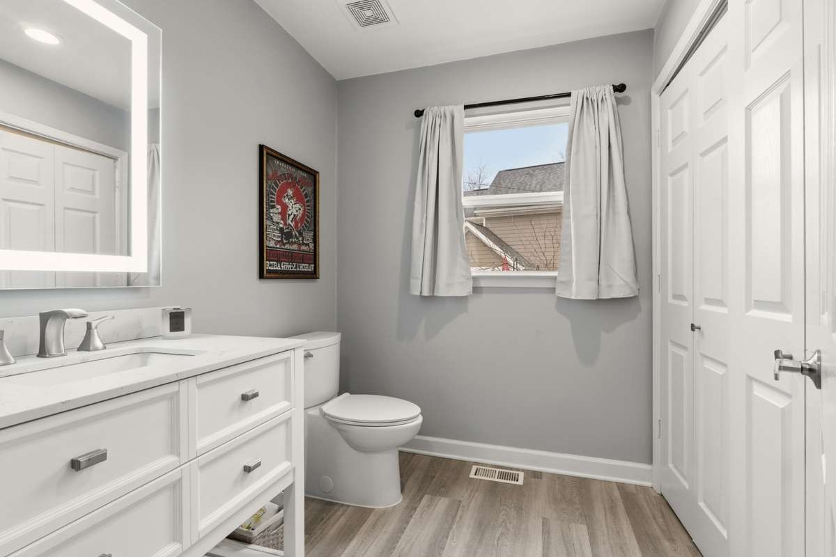 Stylish half bath featuring modern vanity and neutral finishes.