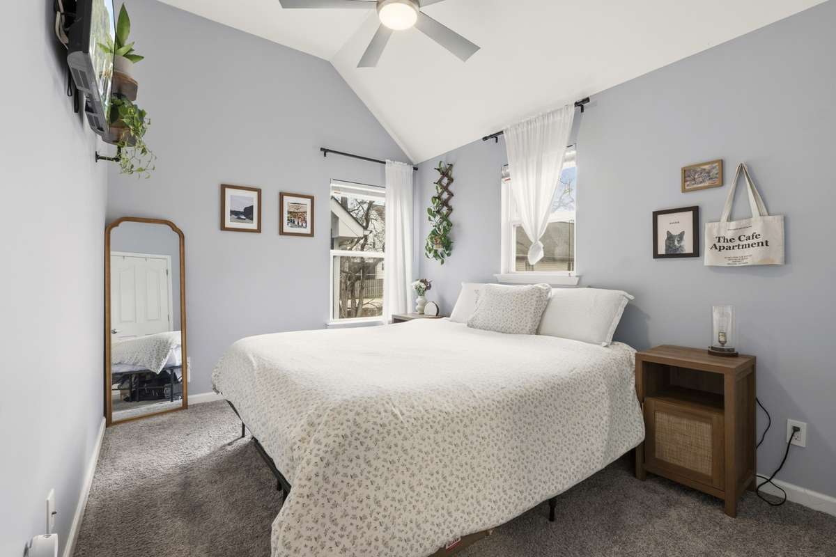 Bright secondary bedroom with vaulted ceilings
