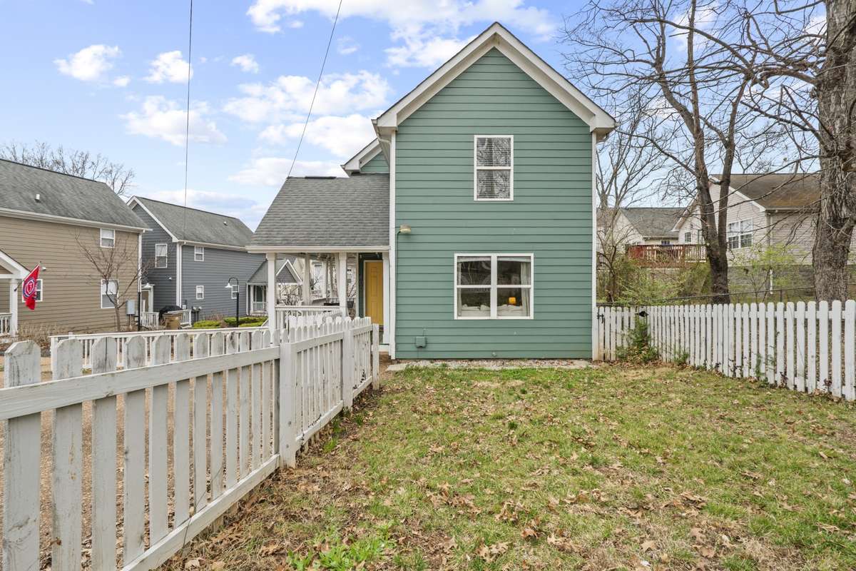 White picked fence with a yard.