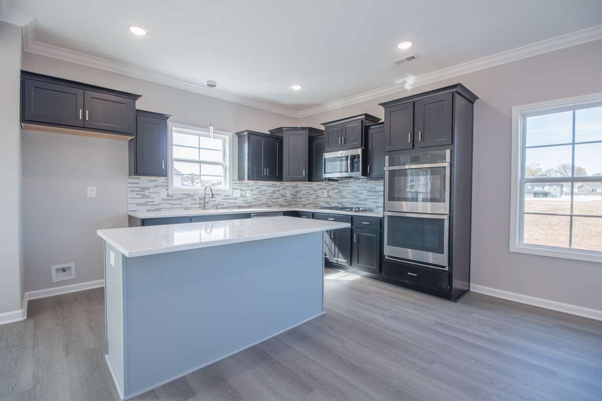 EXAMPLE>>>Large Kitchen with a Cooktop, SMART Double Oven, Granite Countertops, Tile Backsplash, Recessed Lighting, Large Island and Lots of Cabinetry - All with Soft Close Doors and Drawers!!