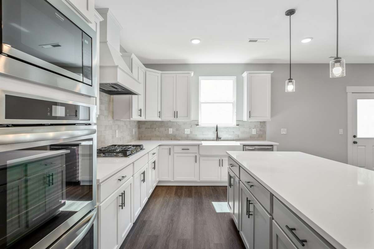 Model of the Henry floorplan.  Colors and selections may vary.  Gourmet kitchen with Hood and double ovens shown.  This option is available.